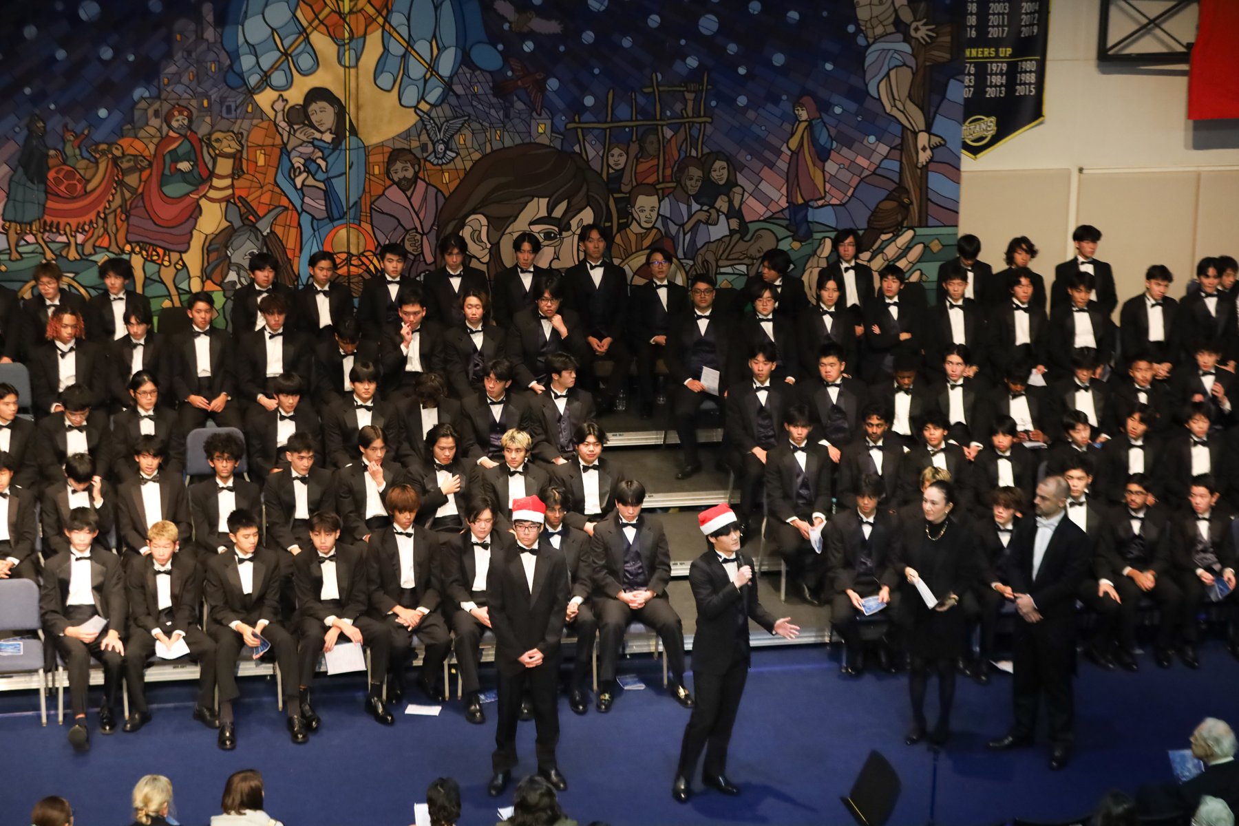 A choir performing together on a concert stage.